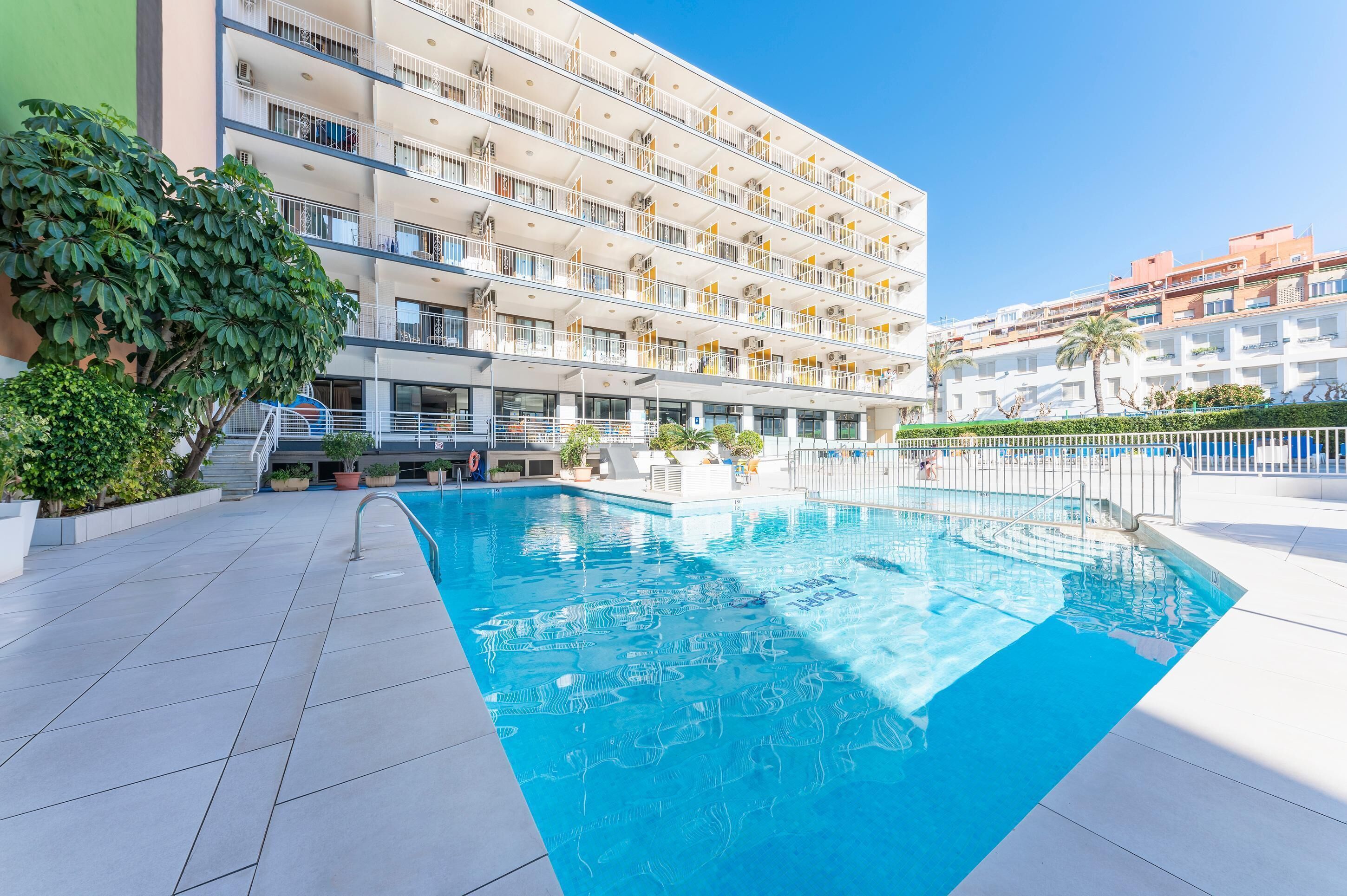 Una piscina al aire libre, tumbonas