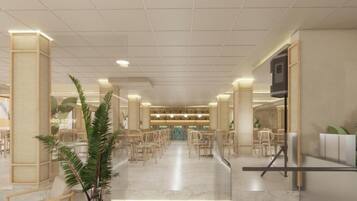 Un vestíbulo de hotel con una zona de estar central, un mostrador de recepción y una escalera.