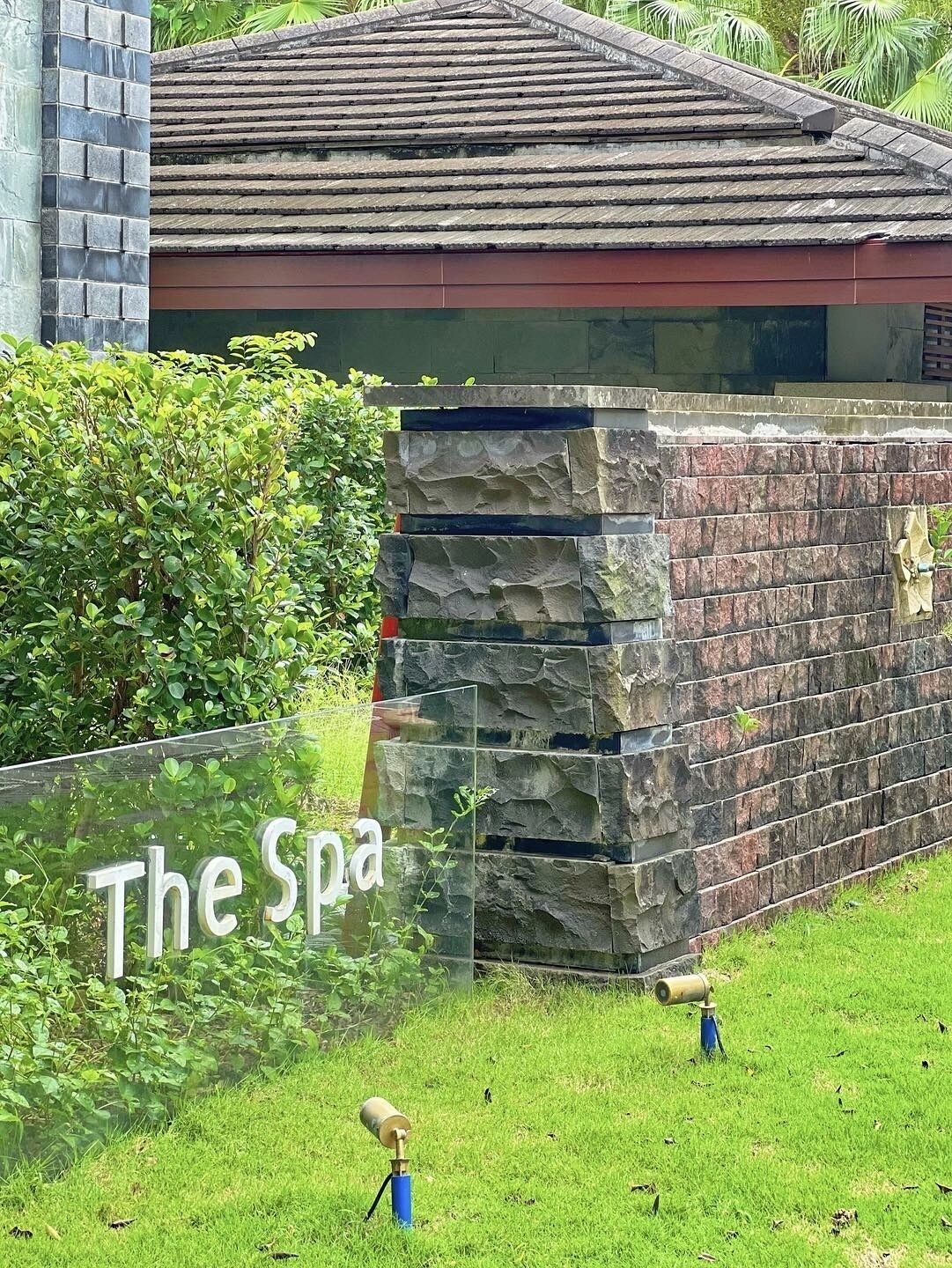A spa with a stone wall and a sign that reads "The Spa".