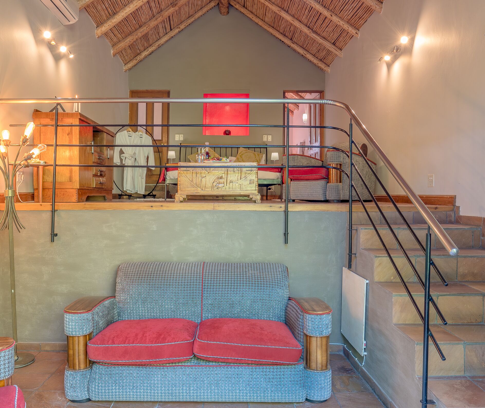 A staircase leading to a loft area with a cushioned seating area below.