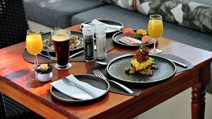 A dining table with a meal, drinks, and condiments. - Mimosa Lodge (Montagu)