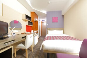 A hotel room with a bed, a desk with a computer, a chair, a TV, and a mirror. - Hotel MyStays Asakusa (Tokyo)