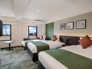 A hotel room with two beds, a small table, and a city view. - Hotel MyStays Asakusa (Tokyo)