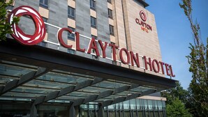 The Clayton Hotel with a modern facade, large windows, and a prominent logo. - Clayton Hotel Leopardstown (Dublin)