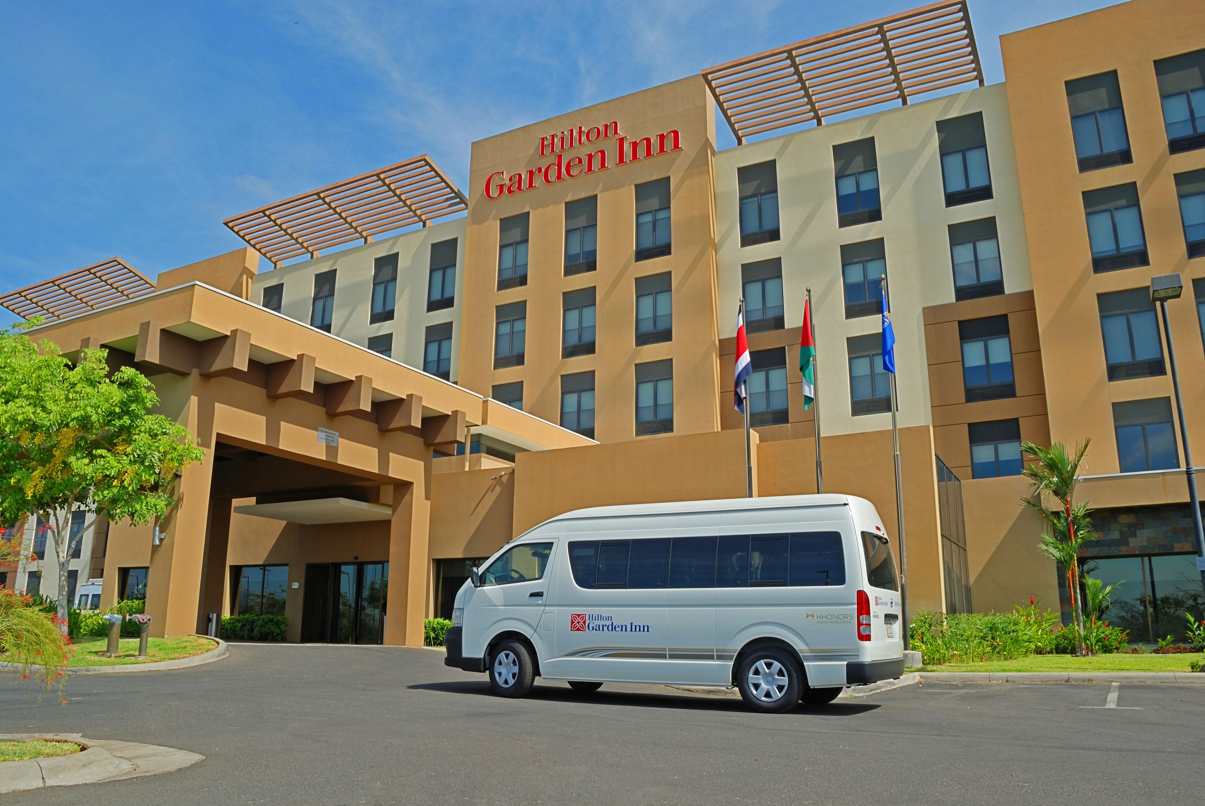 A modern building with a sign reading "Hilton Garden Inn."