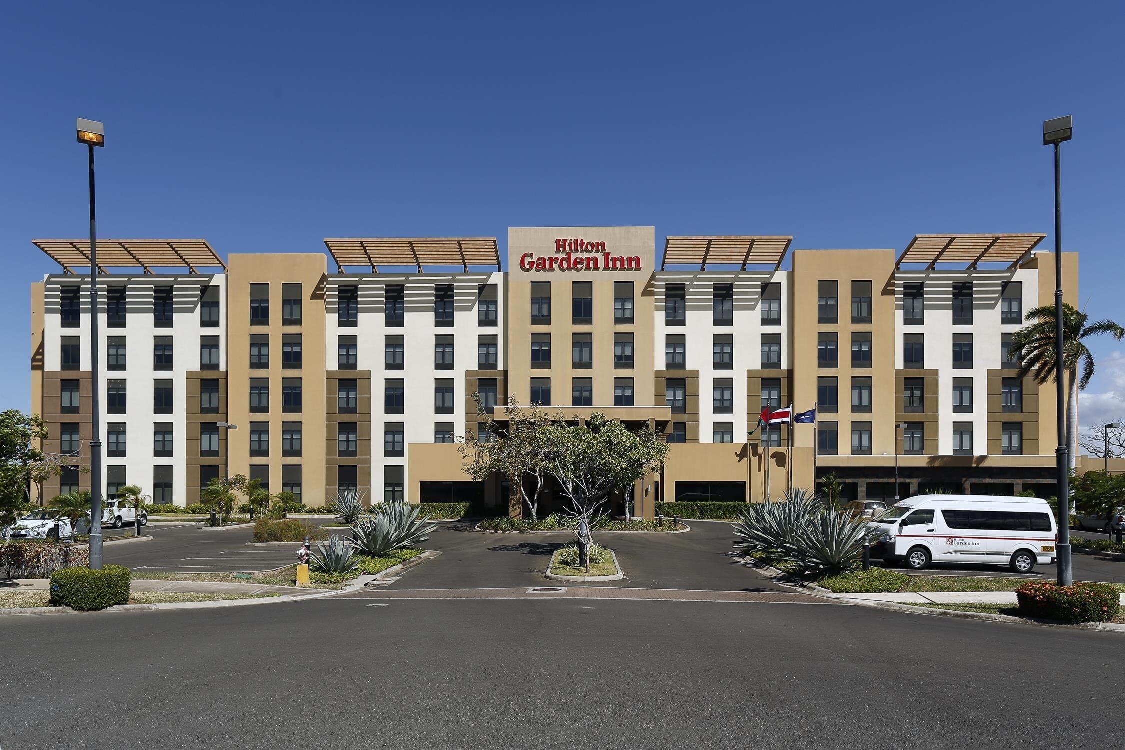 A Hilton Garden Inn hotel with a modern facade, multiple floors, and a central entrance.