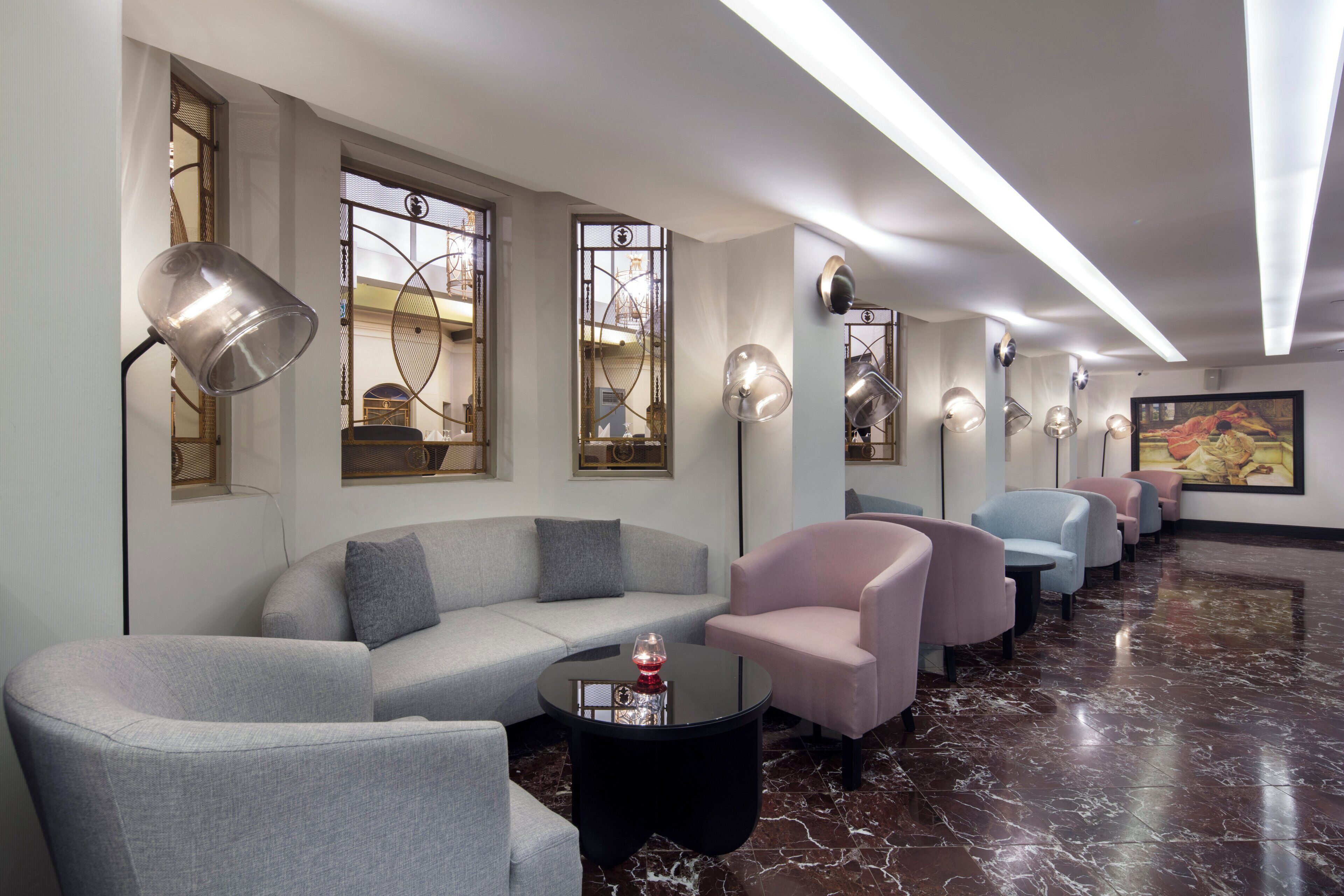A modern lounge area with sofas, armchairs, and a coffee table.