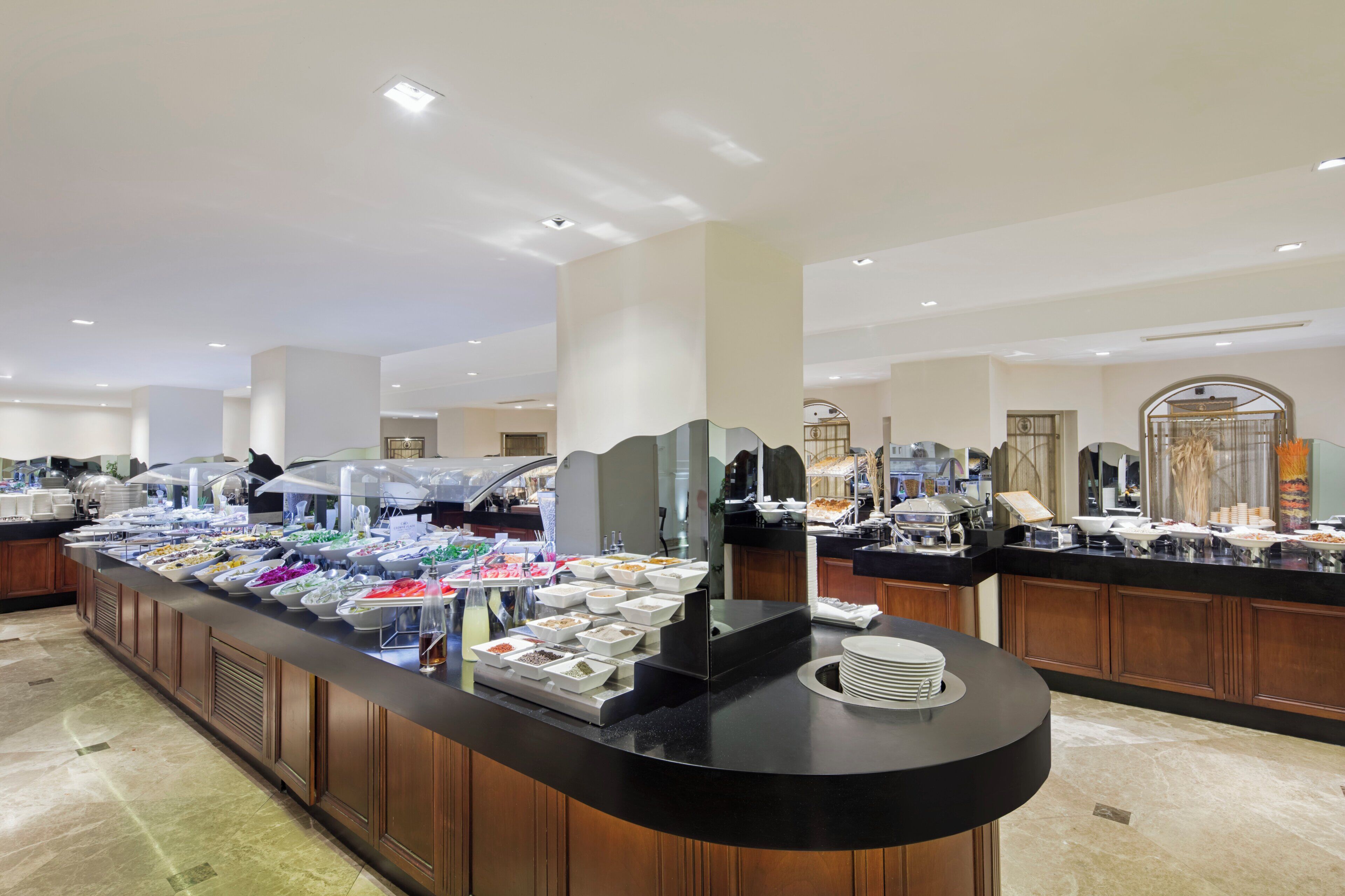 A buffet setup with various food items and a self-service station.