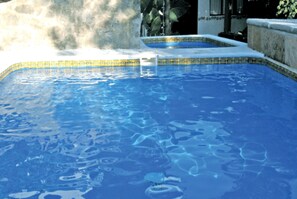 Una piscina al aire libre, tumbonas