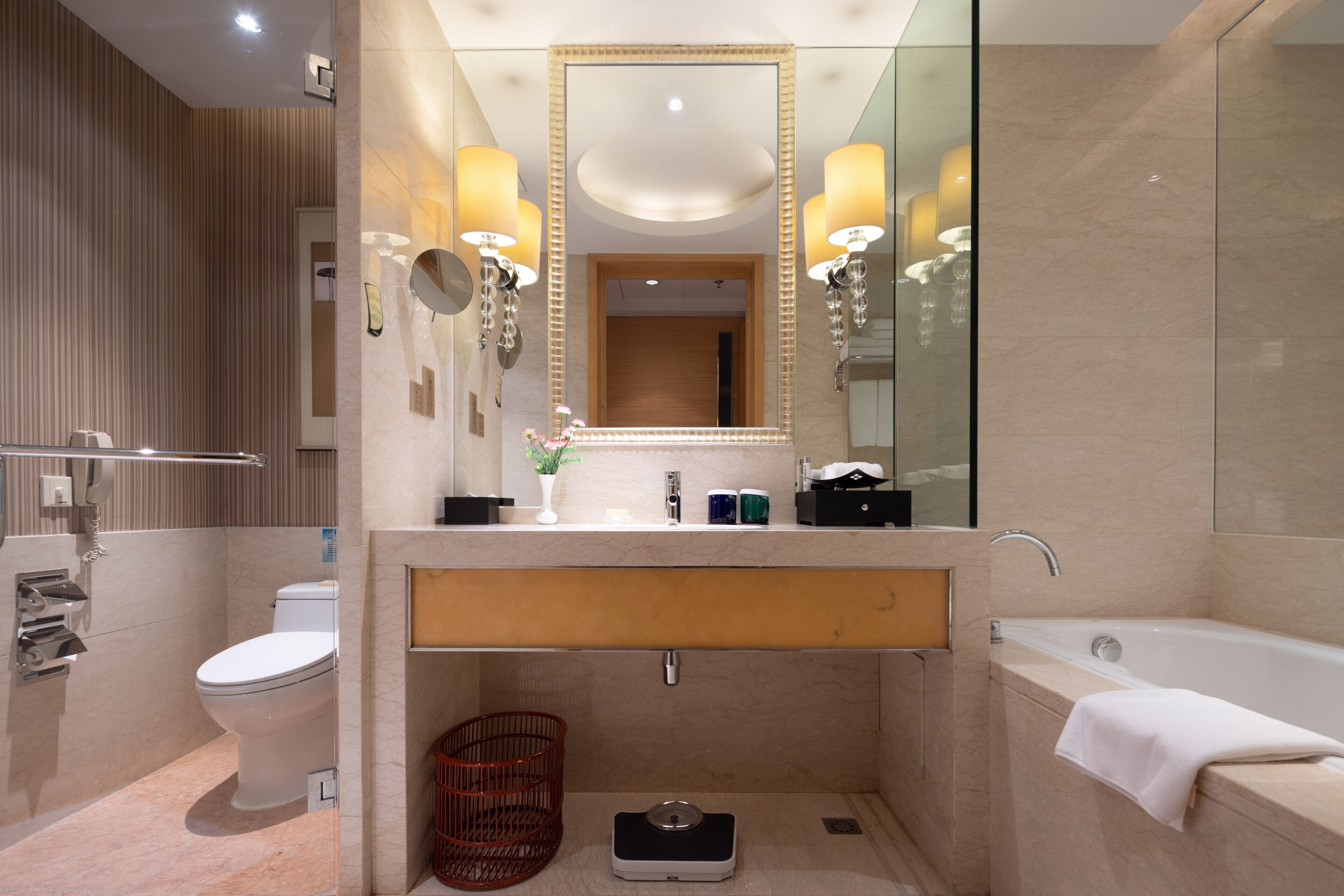 A modern bathroom with a toilet, sink, and bathtub.