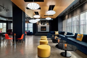 A modern lounge area with a fireplace, seating, and pendant lighting.