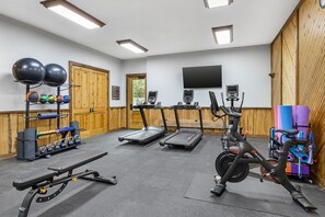 A gym with treadmills, stationary bikes, and various exercise equipment. - Hilton Grand Vacations Club Stonewater Cove Shell Knob (Shell Knob)