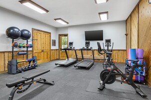 A gym with treadmills, stationary bikes, and various exercise equipment.