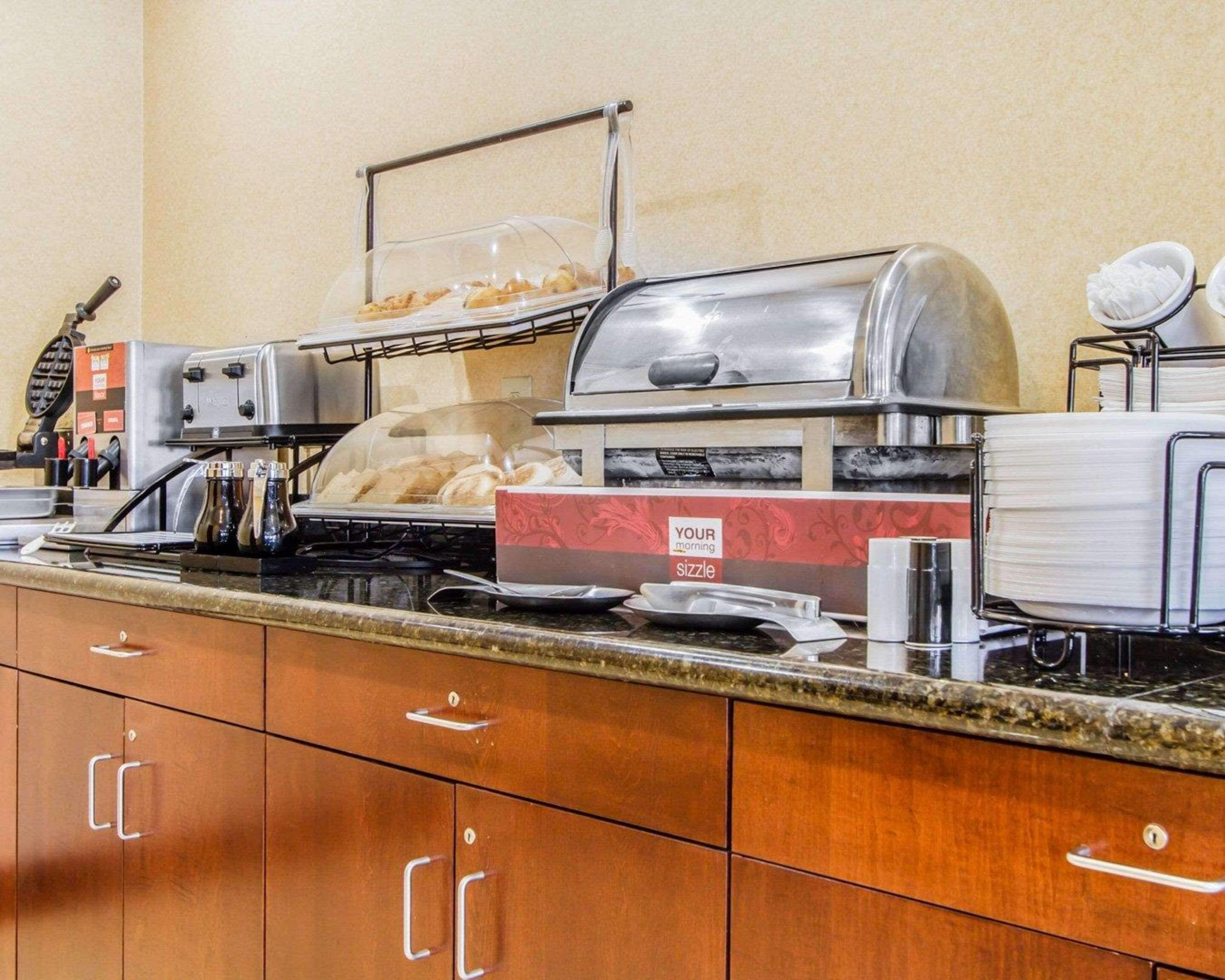 A breakfast bar with a coffee machine, toaster, and a sizzle station.