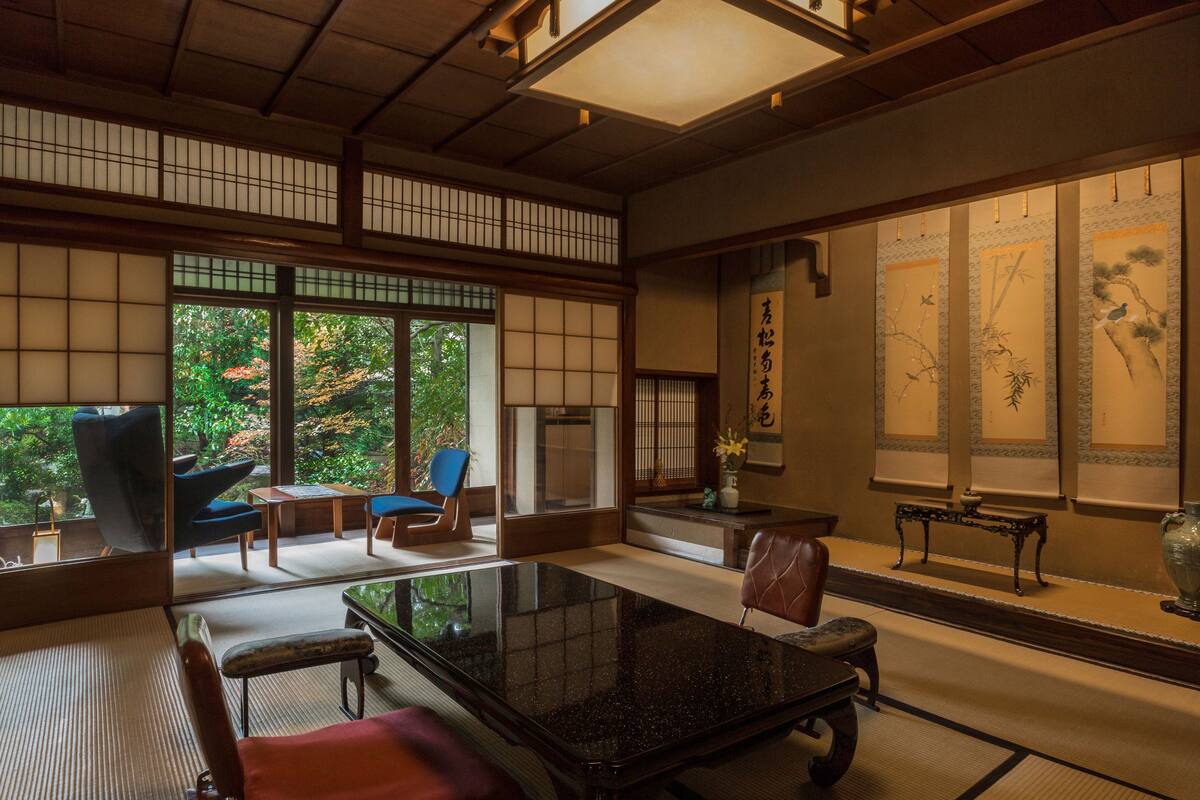 A traditional Japanese room with tatami flooring, a low table, and shoji screens.