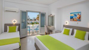 A hotel room with two beds, a desk, and a balcony with a view. - Hotel Makarios (Santorini)