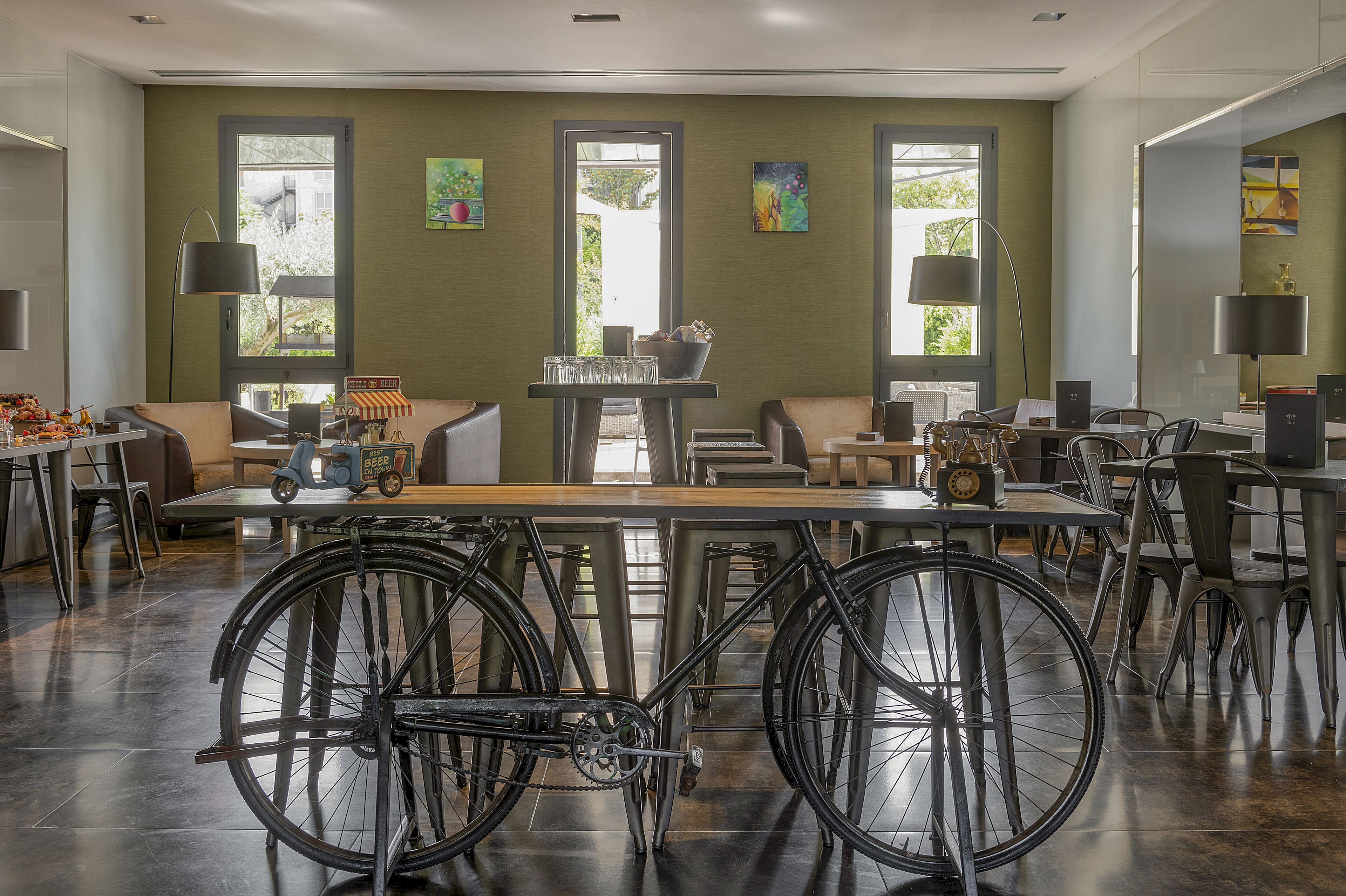 A modern interior with a dining area, seating, and bicycles.