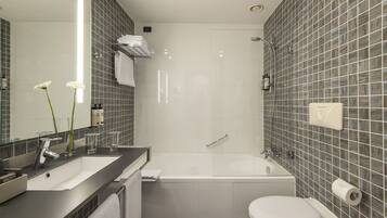 Un bagno moderno con vasca, servizi igienici e lavandino.