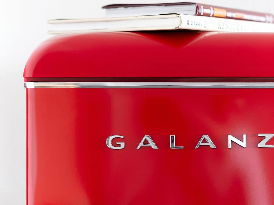 A red vintage suitcase with the brand name "GALANZ" visible on the side.