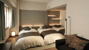 A modern bedroom with a large bed, bedside tables, a nightstand, and a built-in bench. - Ginza Grand Hotel (Tokyo)