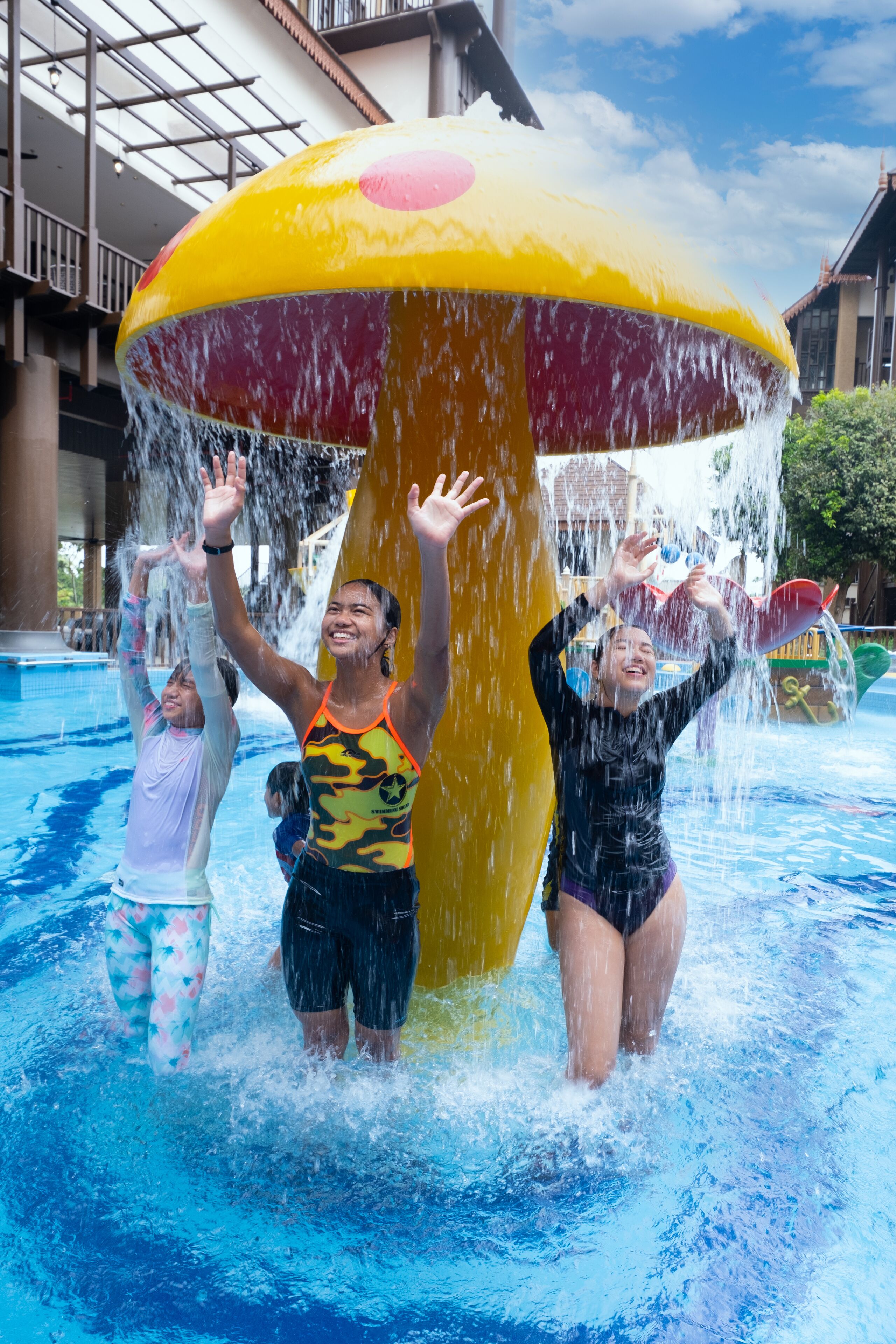 A water play area with a large yellow mushroom-shaped water feature.