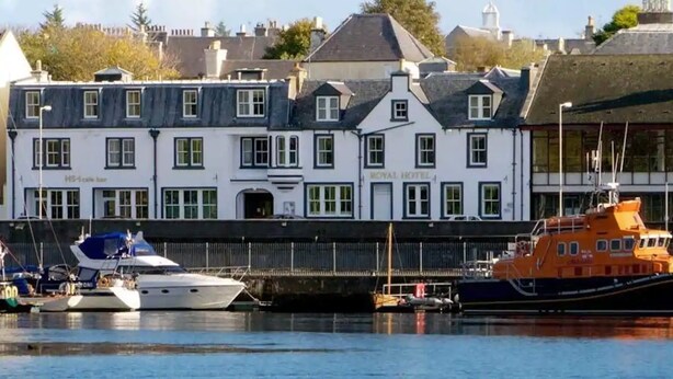 A white building with multiple windows and a sign reading "Royal Hotel." - The Royal Hotel (Stornoway)
