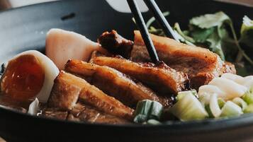 A bowl of food with chopsticks.