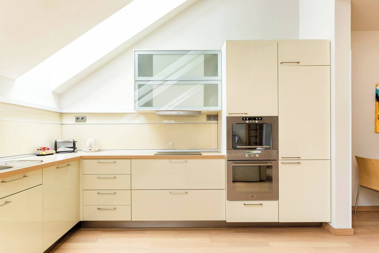 A modern kitchen with a built-in oven, a microwave, and a toaster.