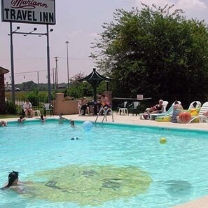 A swimming pool area with lounge chairs and a sign for Mariann Travel Inn. - Mariann Travel Inn Scottsburg (Scottsburg)