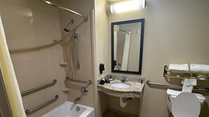 A bathroom with a bathtub, a sink, a toilet, and a shower. - Sleep Inn & Suites at Six Flags (San Antonio)