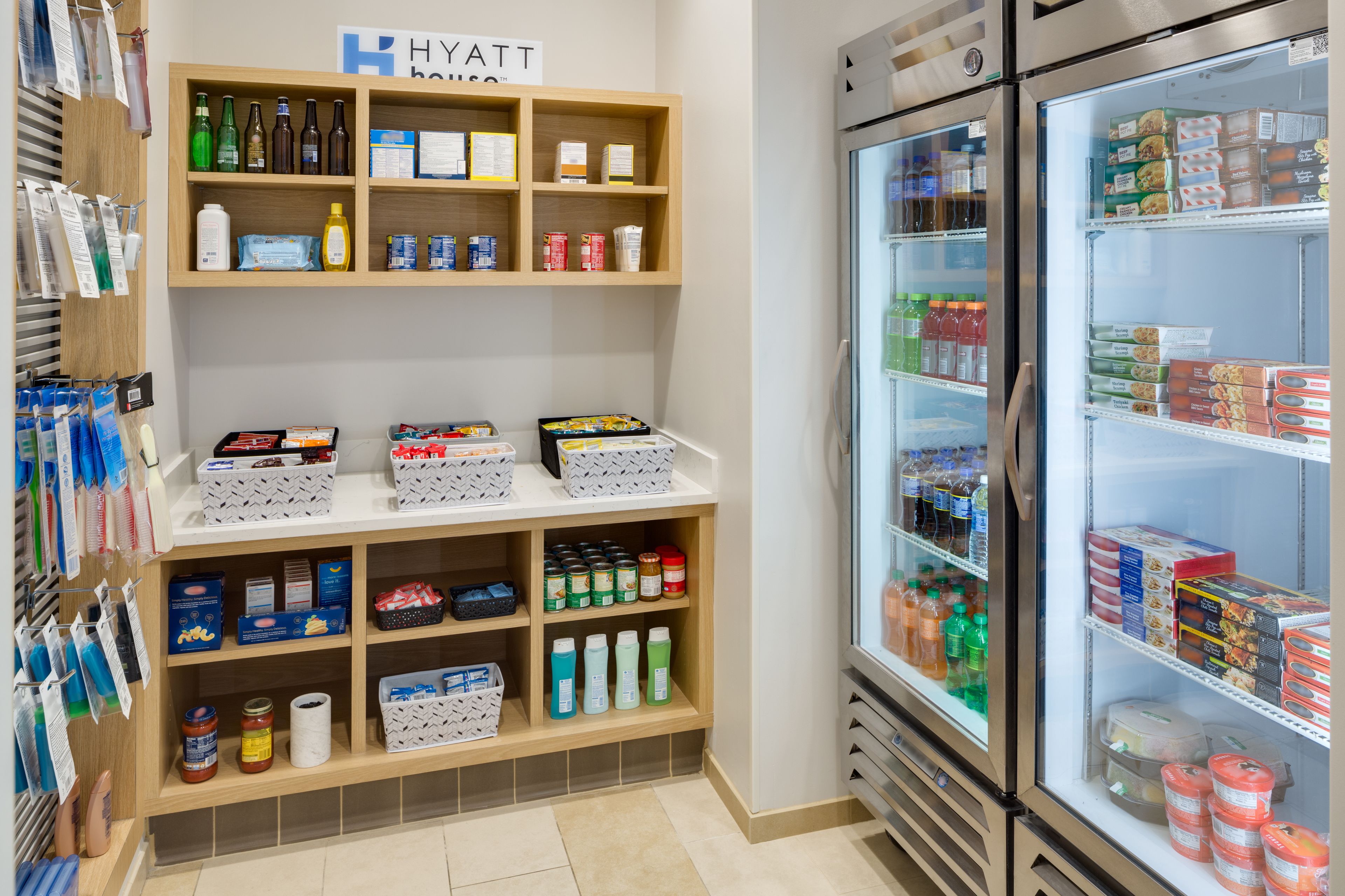 A hotel minibar with various beverages, snacks, and toiletries.