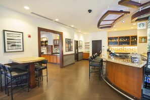 A bar area with a counter, seating, and a coffee machine. - Hyatt Place Lake Mary/Orlando North (Lake Mary)