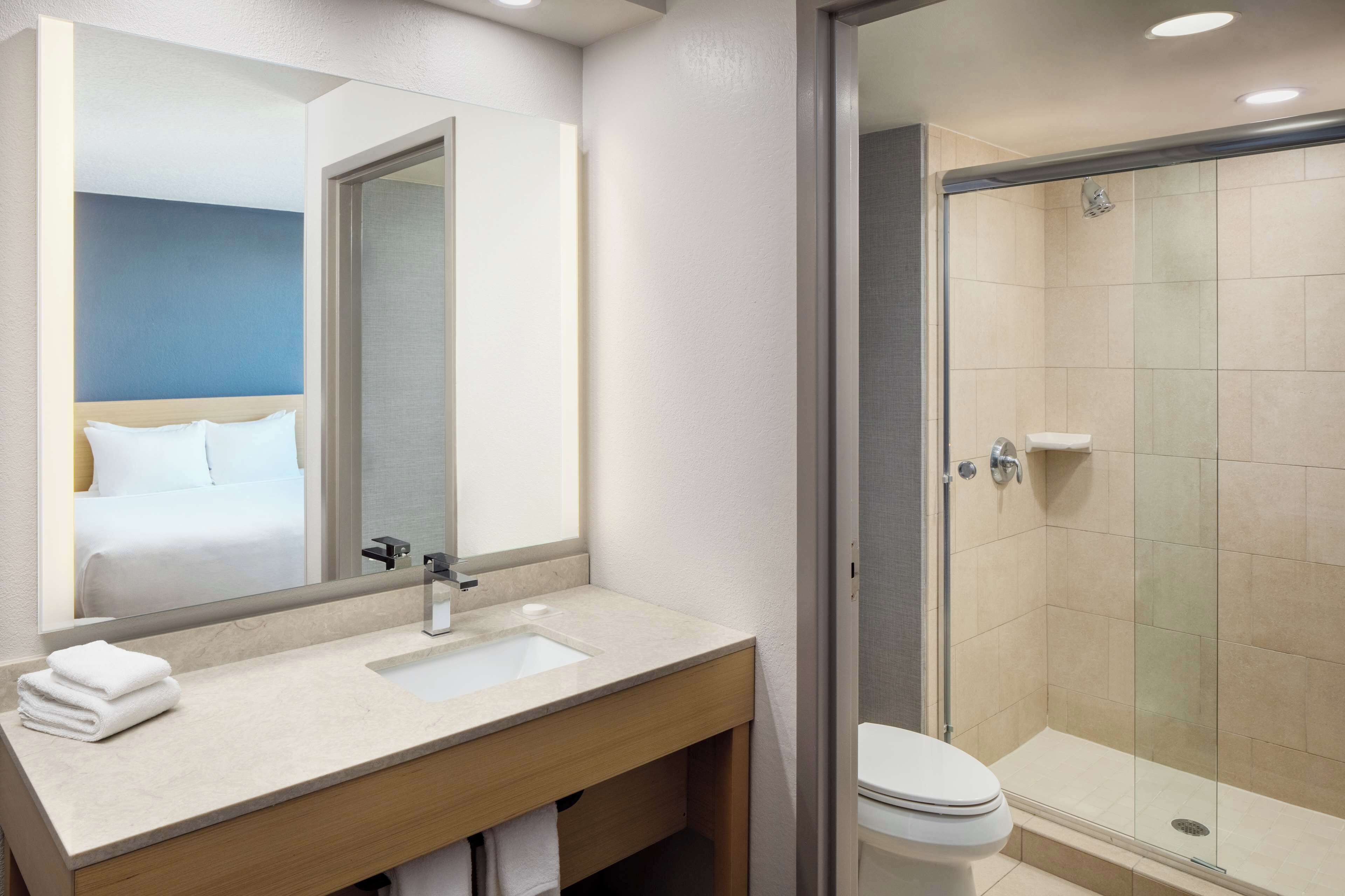 rainfall showerhead, designer toiletries, hair dryer, towels