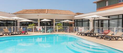 Seasonal outdoor pool, open 7:00 AM to 8:00 PM, pool umbrellas