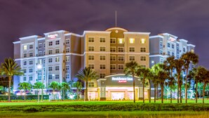 A multi-story hotel with a prominent "Residence Inn" sign, featuring a central entrance and multiple windows on each floor. - Residence Inn by Marriott Clearwater Downtown (Clearwater)