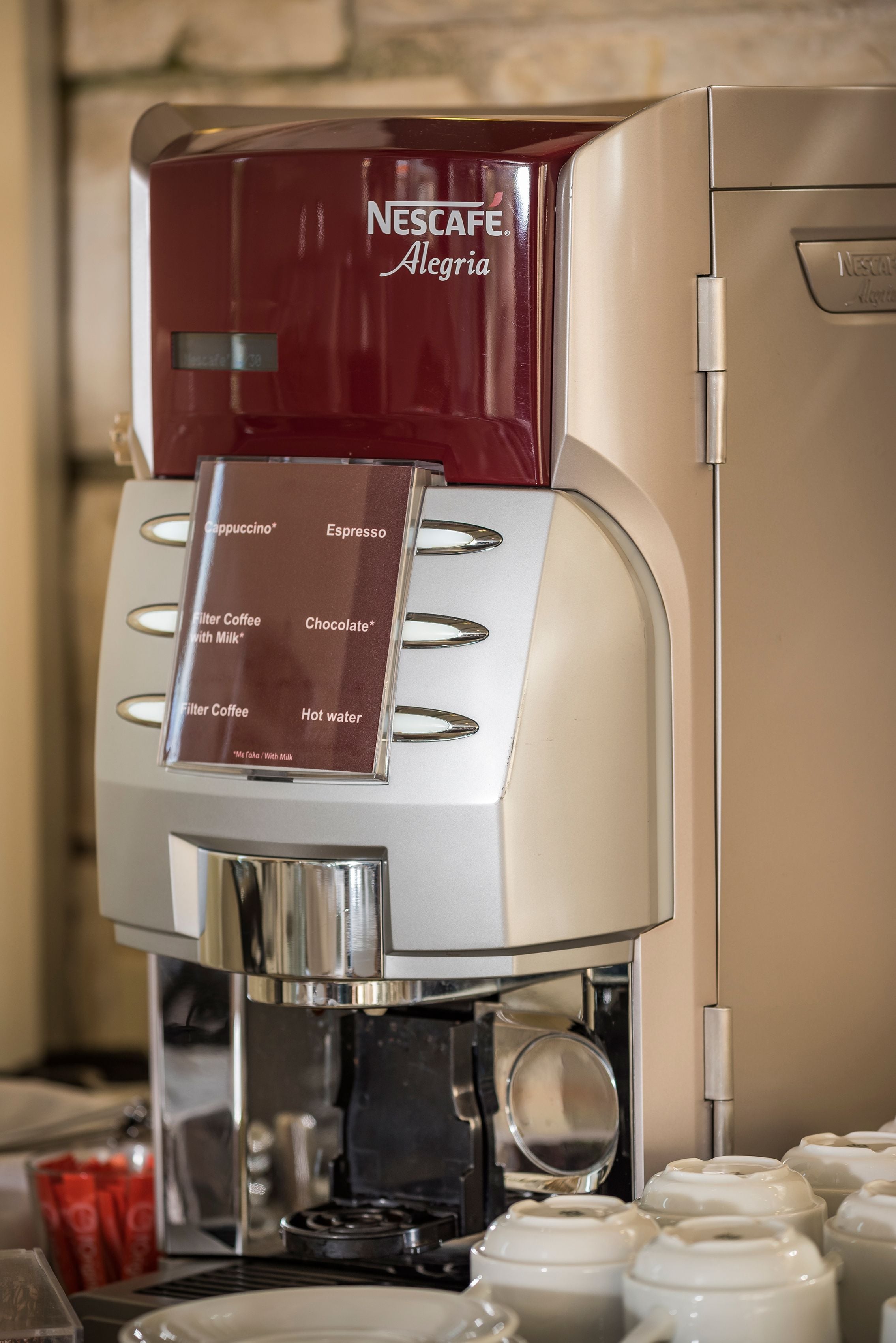 A Nescafé Dolce Gusto coffee machine with options for espresso, cappuccino, filter coffee with milk, chocolate, and hot water.