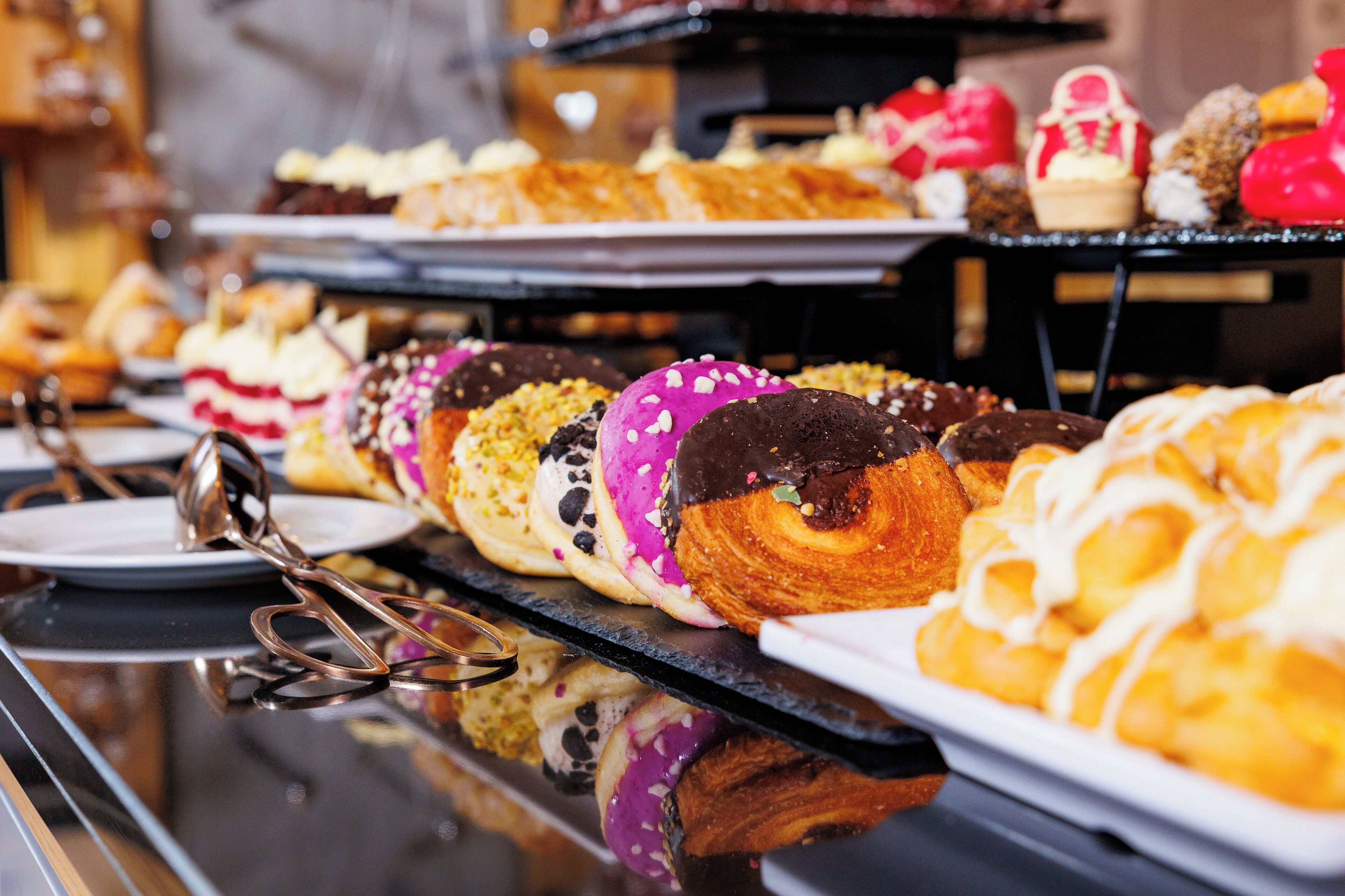 A buffet with various pastries and desserts.