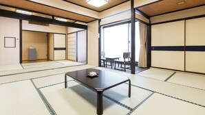 A traditional Japanese room with tatami flooring, a low table, and sliding doors. - Kyoto Hotel SANOYA (Kyoto)