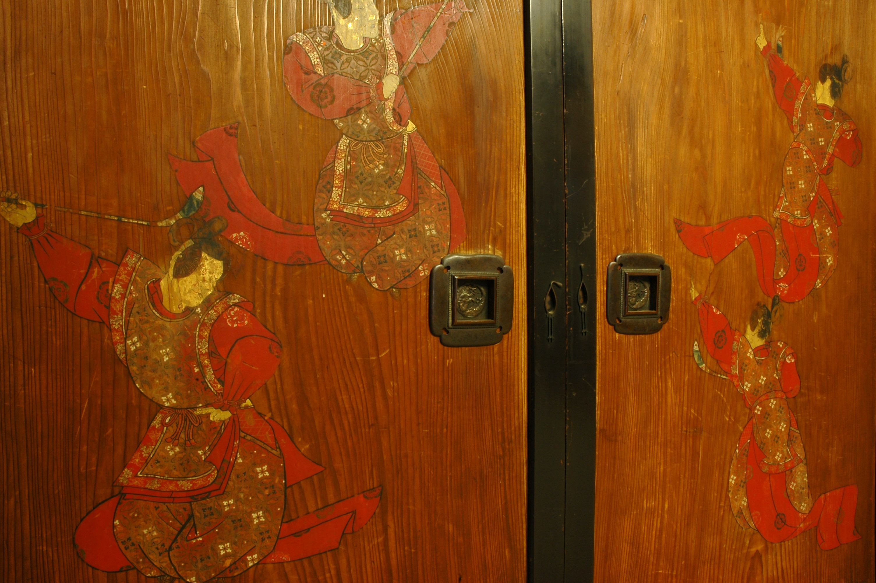 A wooden door with traditional Asian-style artwork.