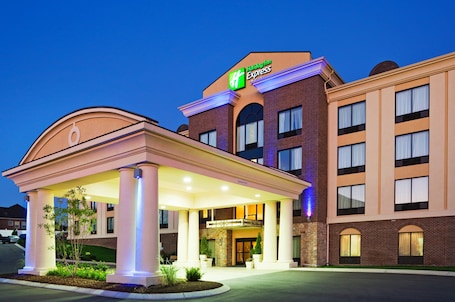 A Holiday Inn Express hotel with a covered entrance, brick facade, and illuminated signage.