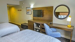 A hotel room with two beds, a desk with a chair, a flat-screen TV, a mirror, and a bedside lamp. - Hampton Inn & Suites Chesapeake-Battlefield Blvd. (Chesapeake)