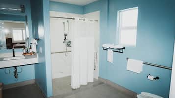 Une salle de bain équipée d’une douche, de toilettes, d’un lavabo et d’un porte-serviettes.