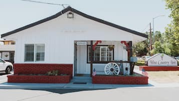 A white building with a sign reading "Office" and "Wine Country Inn."