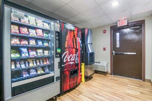 A vending machine with snacks and a Coca-Cola machine.