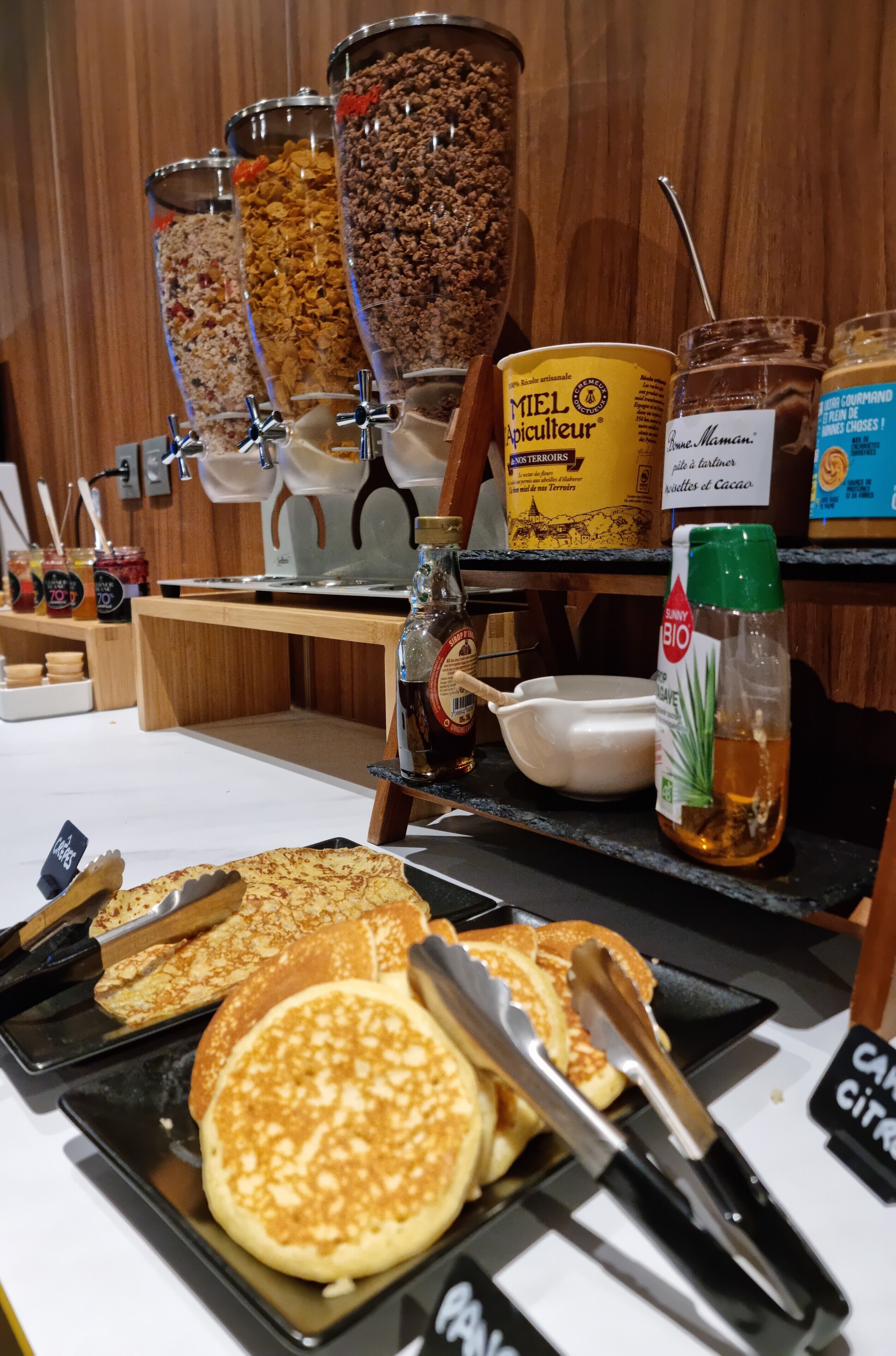 A breakfast buffet with various food items and condiments.