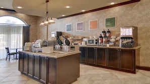 A breakfast bar with a coffee machine, toaster, and food display. - Comfort Suites Frisco (Frisco)