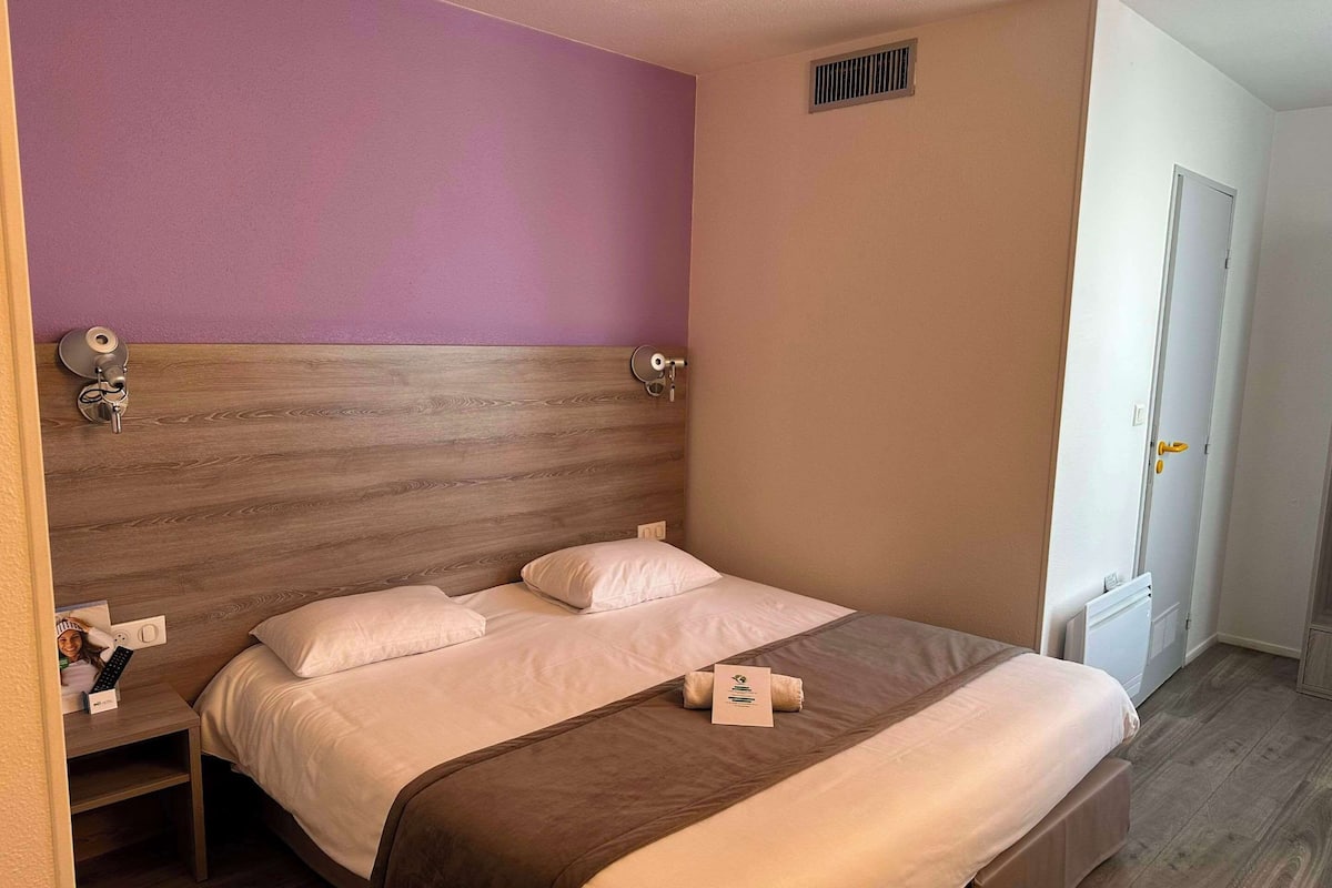 Cozy retreat with a single bed, bedside table, and modern amenities.