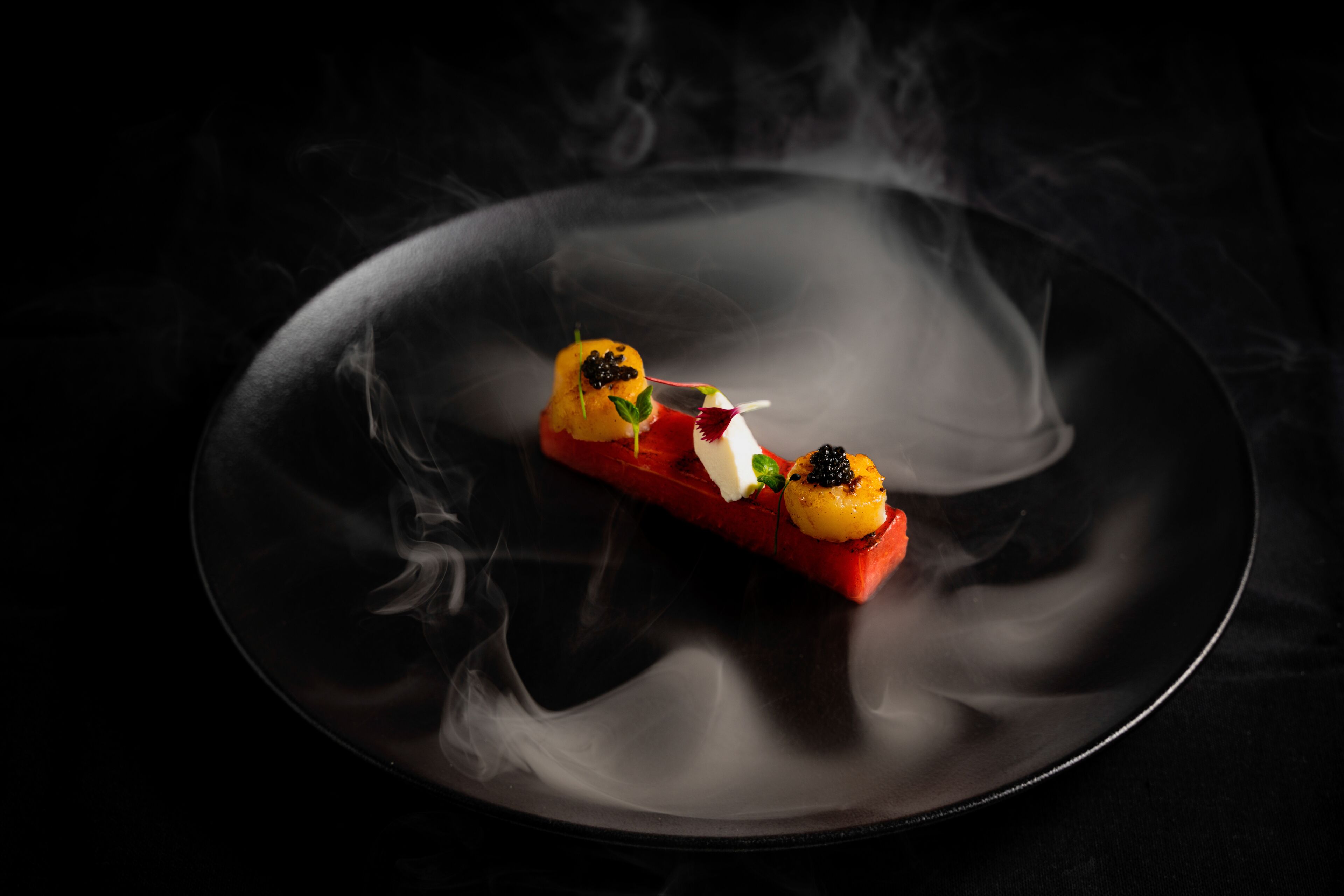 A dessert on a plate with smoke effects.