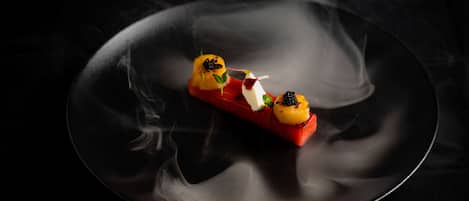 A dessert on a plate with smoke effects.