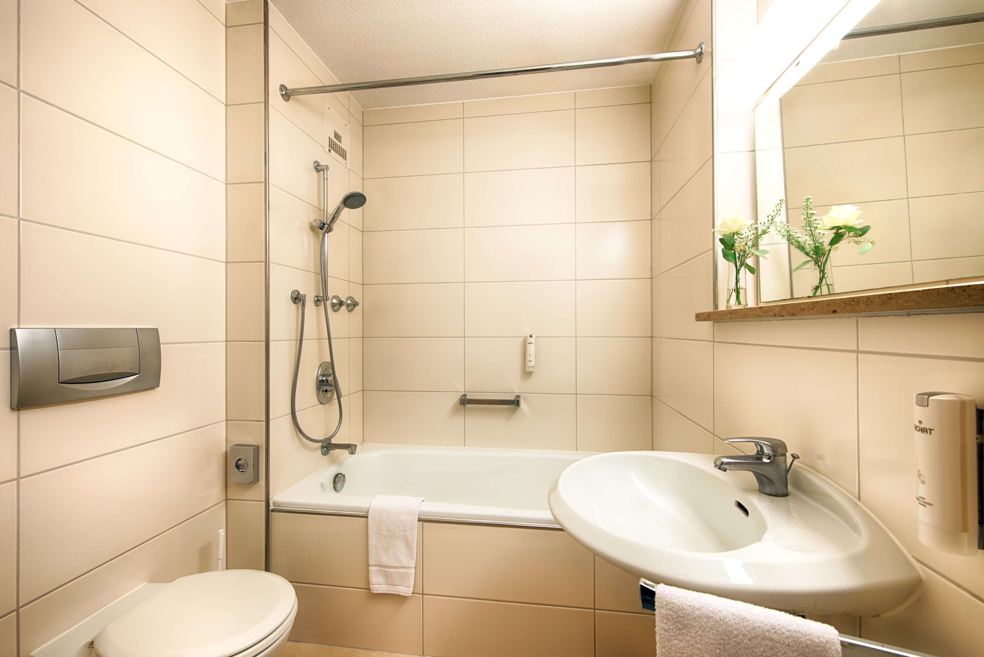 A bathroom with a toilet, a bathtub, a sink, and a shower.